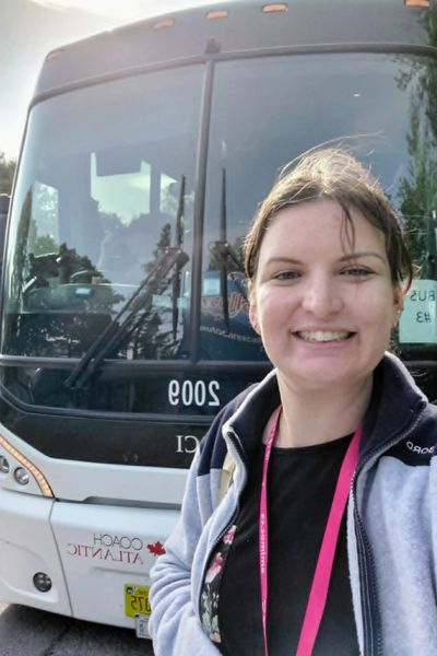 quebec city tour guide in front of a bus