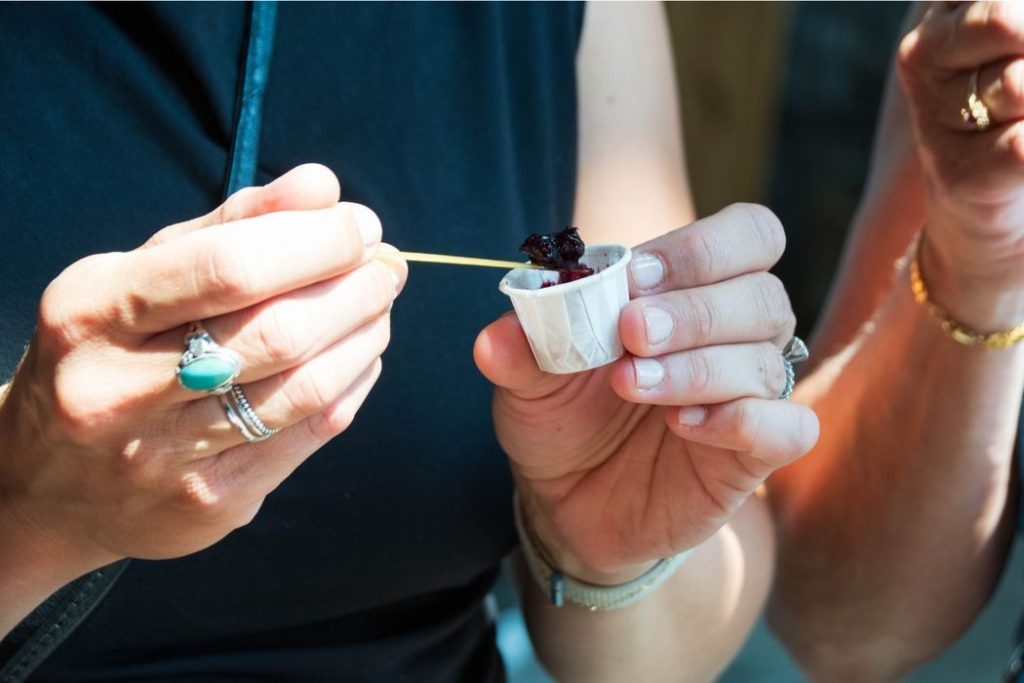 hands with jam tastings on food tour on orleans island